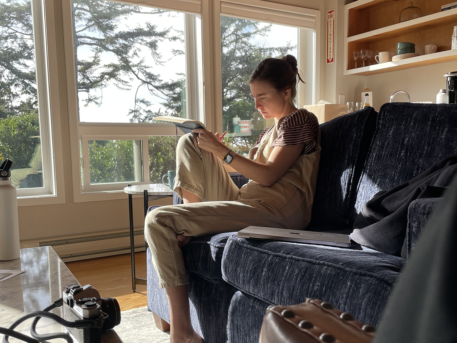 Reading in a window-lit armchair overlooking the Oregon coast